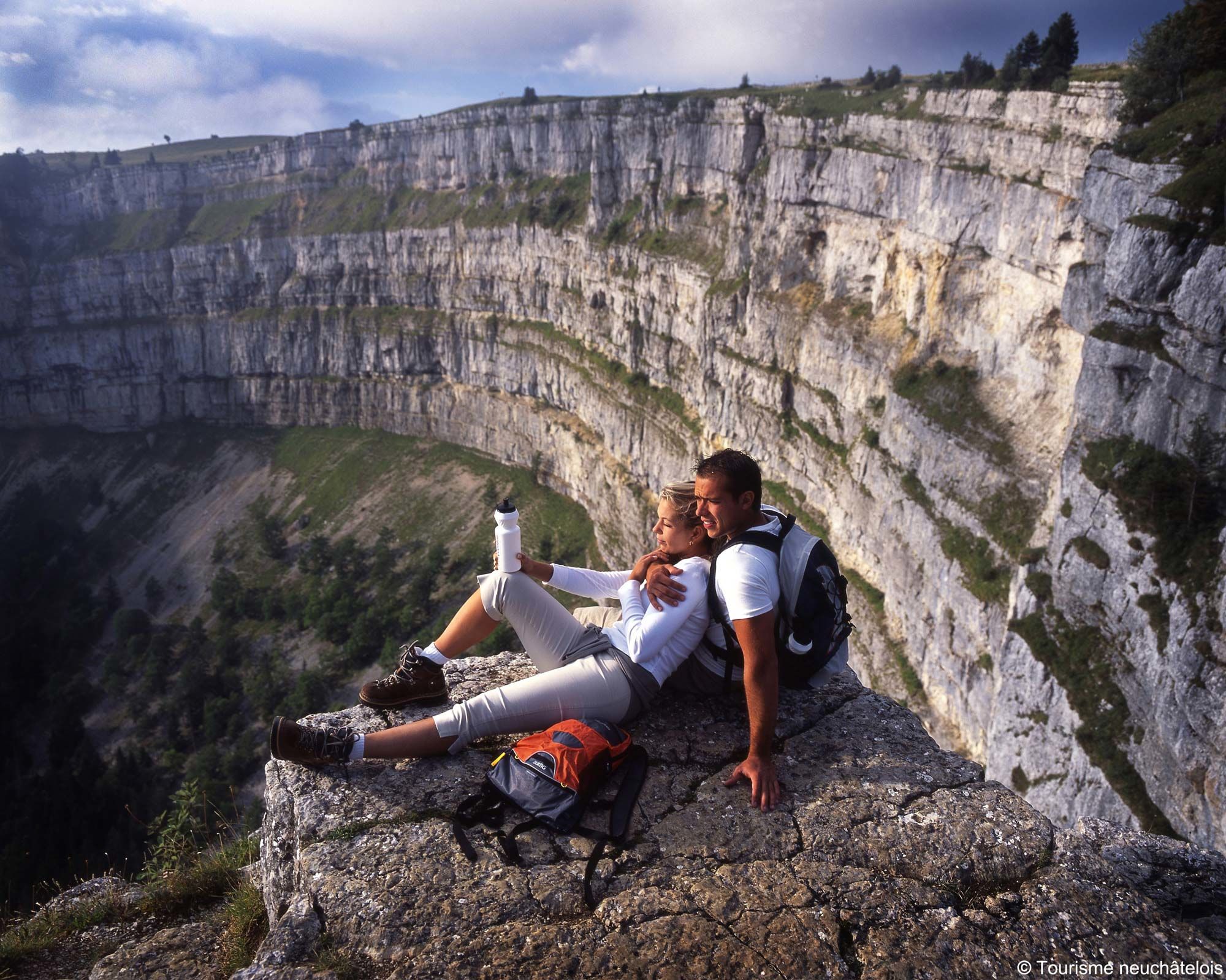 Hikers overlooking the spectacular cliffs of the Creux du Van
